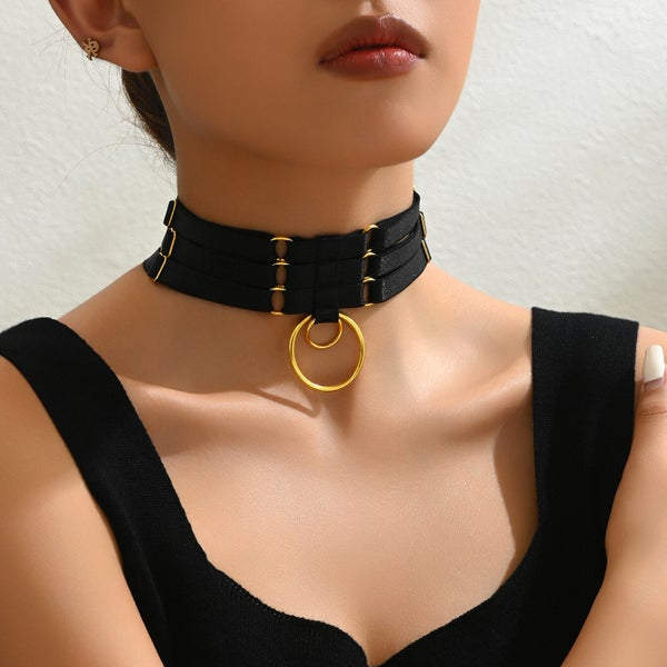 Black triple-ring choker with three strap rows and gold circular ring pendant